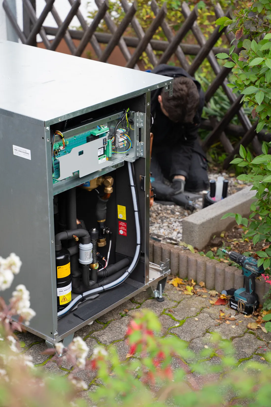 Geöffnete Wärmepumpe während der Montage im Garten